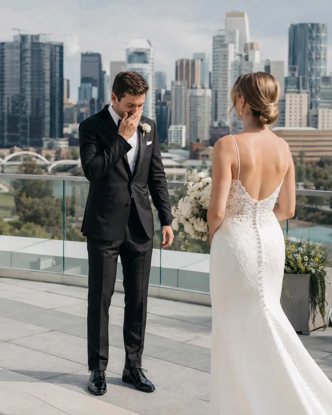 Groom tearing up at a first look on a Calgary rooftop