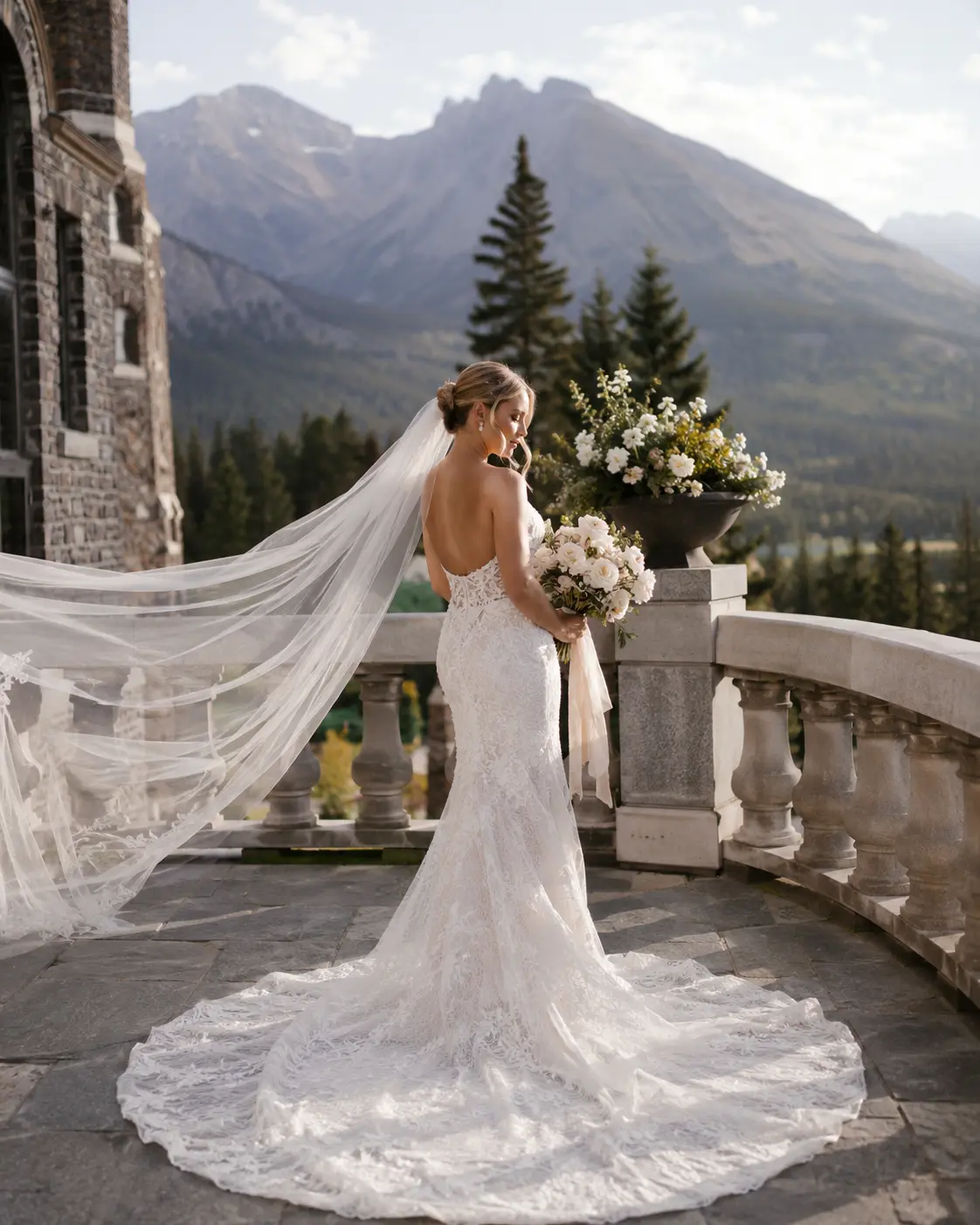 Bride with cathedral veil on a castle terrace in Banff